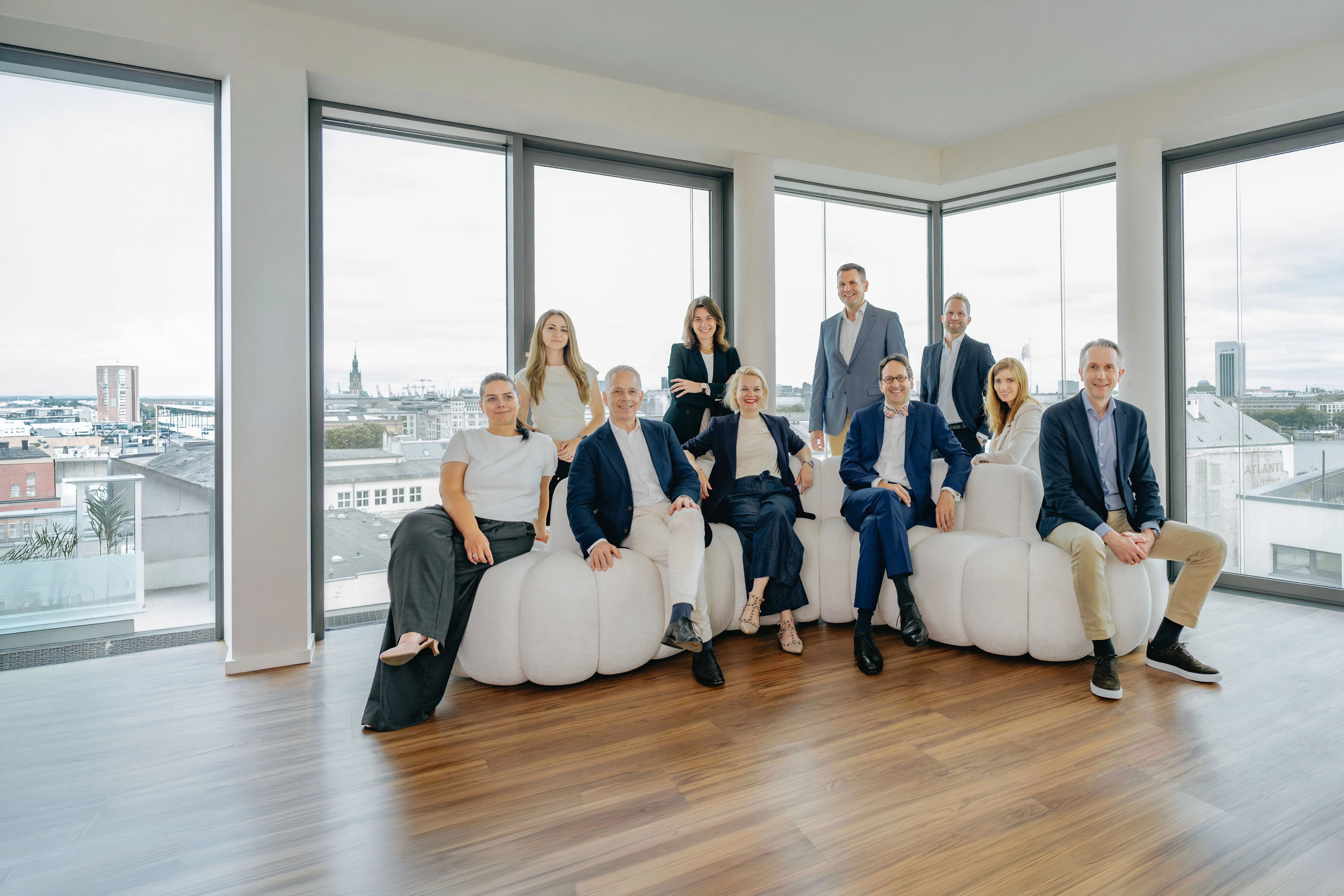 Das ARTANA-Team in den Kanzleiräumen mit Blick über Hamburg